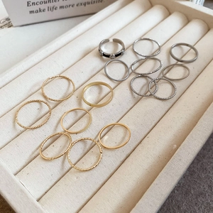 Detailed macro view of minimalist gold and silver ring set in a velvet jewelry box