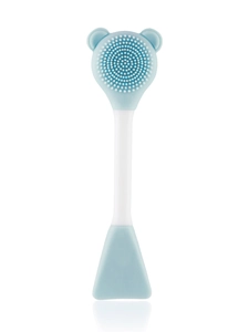 Detail of dual-ended silicone face brush with blue bear head and mud mask spatula applicator