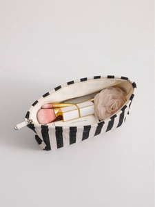 Minimalist black and white striped canvas makeup bag with zippers on a white background
