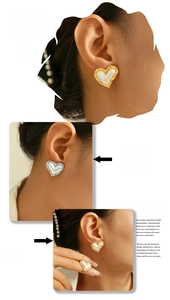 Detailed view of 18K gold plated heart studs and ring with wavy metal texture