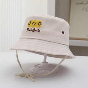Detail of beige cotton bucket hat featuring TripleSmile embroidery and woven wind rope