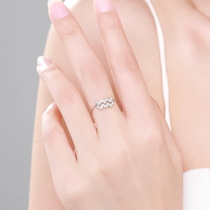 Minimalist 925 sterling silver wave ring with sparkling zircon stones on model finger