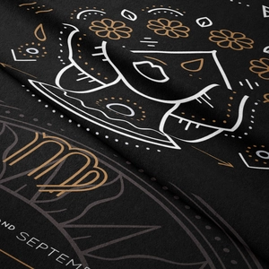 Detail of Virgo zodiac tapestry showing fine gold floral motifs on black micro-velvet fabric