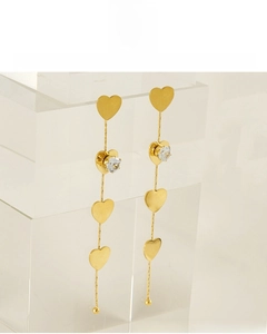 Detail of 18K gold plated long tassel heart earrings with sparkling cubic zirconia