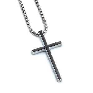 Macro detail of silver cross pendant with black inlay on a polished metal chain