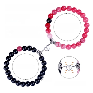 Detailed view of 8mm natural stone couple bracelets with magnetic heart charm and sizing info