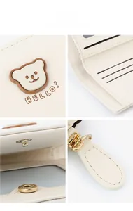 Detailed macro view of cream PU leather wallet with bear motif and metal snap closure