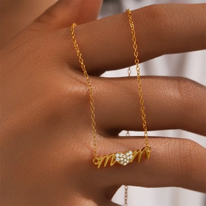 Detailed view of gold Mom pendant necklace with heart-shaped pavé cubic zirconia