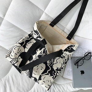 Detail of canvas tote bag showing interior zipper pocket and cartoon character prints