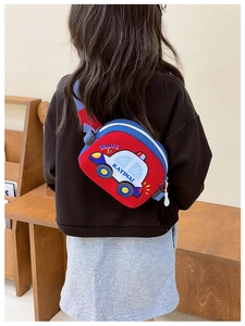 Detail of cartoon car chest bag for kids featuring a 3D police car design and blue strap