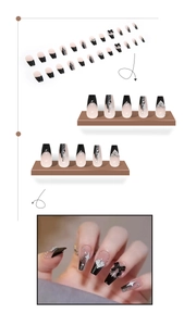 Detail of 3D black bow press-on nails with silver star patterns and pearl accents