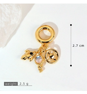Close-up of a 2.7cm golden travel pendant with zircon charms on a white background