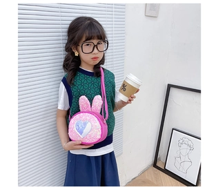 Close-up of pink sequin rabbit ear crossbody bag with a silver heart for young girls