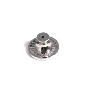Close-up of a silver earring lift back showing detailed radial texture and metal polish