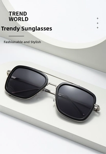 Detail of square black frame sunglasses with silver metal temples on a white platform
