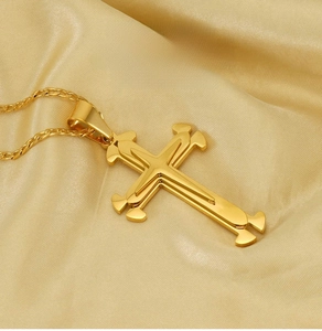 Detail of 18k gold plated double layered stainless steel cross pendant on an O-chain
