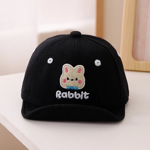 Detailed view of black cotton baby cap featuring cute rabbit and flower embroidery
