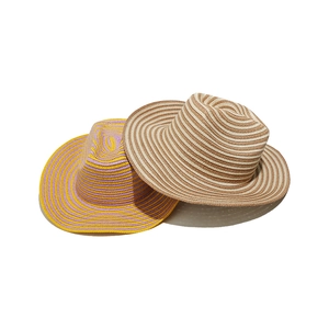 Detail of striped woven paper straw sun hats in yellow-purple and brown-beige colors