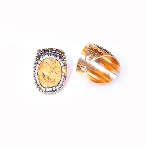 Detail of vintage brass gold ring with faceted brown agate and multi-layer crystal accents