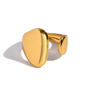 Macro detail of a gold minimalist adjustable ring with an irregular pebble design