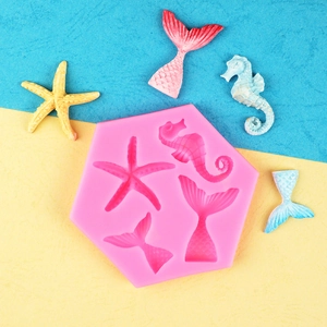 Pink hexagonal silicone mold featuring sea star, seahorse, and mermaid tail shapes