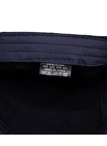 Detail view of 100% cotton care label with washing instructions on a newsboy cap