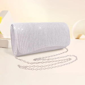 Detailed view of silver evening clutch bag featuring vertical texture and silver chain strap