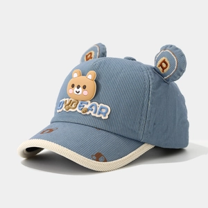 Detail of blue corduroy kids baseball cap with 3D bear ears and rubber patch decoration