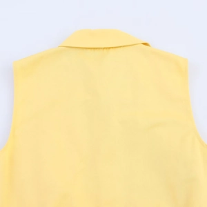 Detail of yellow sleeveless shirt collar showing twill fabric texture and back stitching