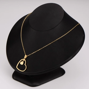 Gold hollow heart pendant necklace displayed on a professional black velvet bust model