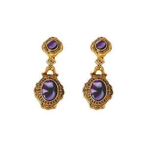 Vintage gold oval earrings with purple gemstones and intricate floral embossed details