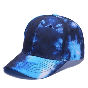 Close-up of tie-dye baseball cap showing blue and white gradient patterns and stitching