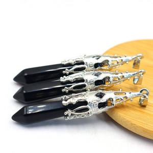 Close-up of black obsidian dragon-shaped pendant necklaces with silver hollow design