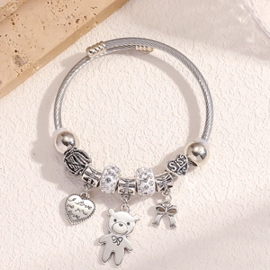Silver charm bracelet with bear heart and bow pendants featuring crystal beads
