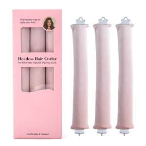 Three pink heatless hair curlers standing next to a branded packaging box
