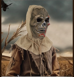Macro detail of scary Halloween scarecrow mask with bloody skull face and burlap texture