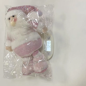 Detailed view of pink sequin Santa plush doll weight measurement on digital scale