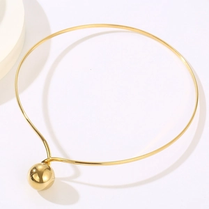 Close-up of a minimalist gold stainless steel choker featuring a glossy metal ball pendant