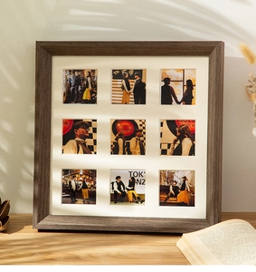 Macro detail of dark brown wooden 9-slot collage frame with white mat for square photos