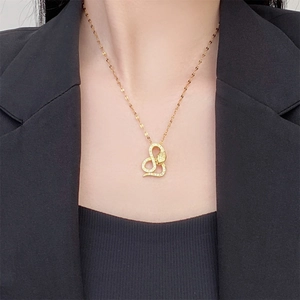 Detail of a vintage 18K gold snake pendant with cubic zirconia on a chic gold chain