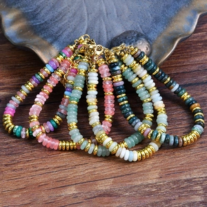 Detailed shot of colorful natural stone beaded bracelets with adjustable gold clasps