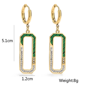 Detail view of gold titanium earrings with green stripes and white zircon, size 5.1cm by 1.2cm