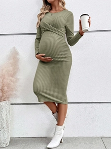Detail of sage green ribbed maternity dress with long sleeves and crossover V-neckline