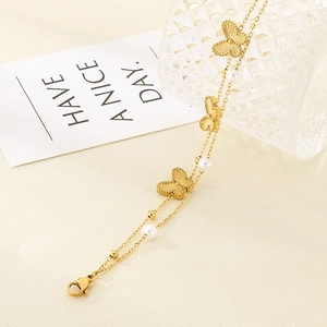Double-layered gold stainless steel bracelet with butterfly charms and white pearls