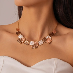 Detailed close-up of a geometric oil-drop square necklace set worn by a fashion model