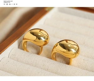 Detailed macro shot of 18k gold plated stainless steel chunky rings in a beige velvet box