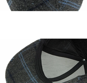 Detail of grey plaid wool baseball cap with blue grid pattern and mesh lining