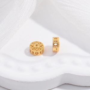 Macro view of gold hollow circular flower spacer bead for DIY jewelry making and bracelets