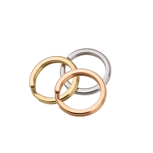 Close-up of interlocked gold, silver, and rose gold stainless steel flat key rings