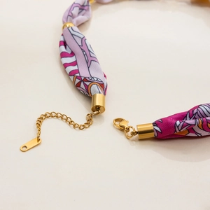 Detail of floral fabric necklace showing gold lobster clasp and adjustable extension chain